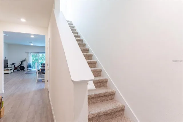 a view of entryway and hall with wooden floor