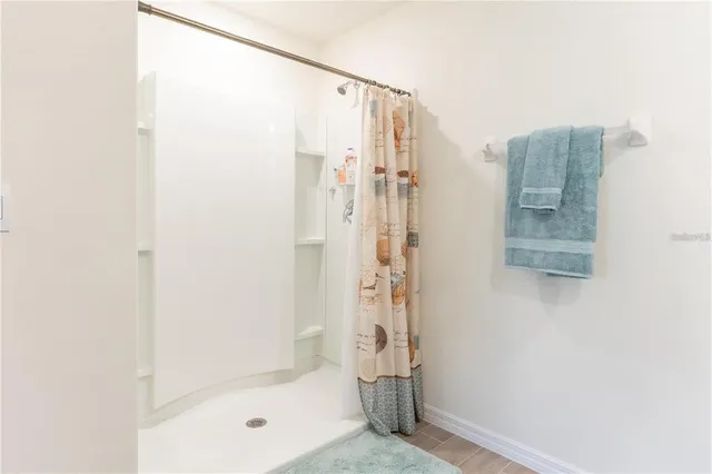 a bathroom with a shower and a glass door