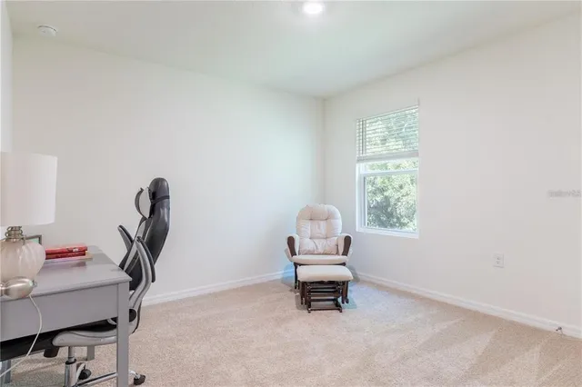 a view of workspace with furniture and a window