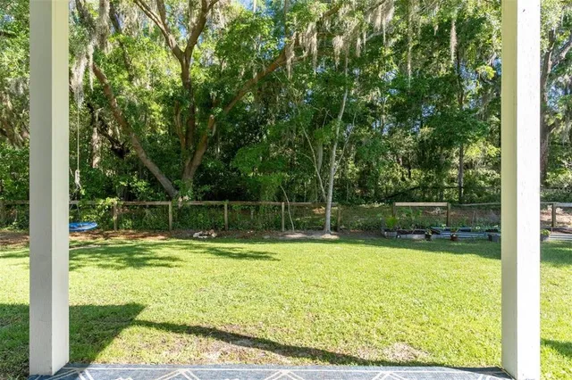 a view of a swimming pool with a yard