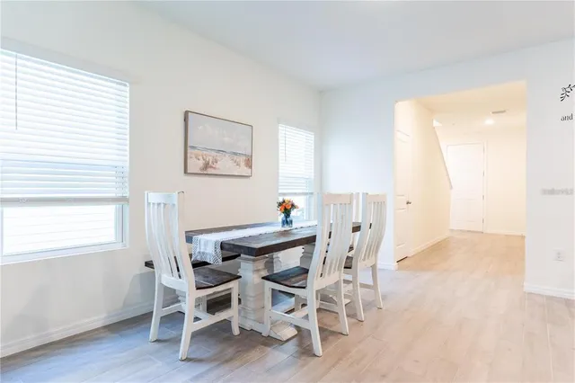 a view of a dining room with furniture and wooden floor