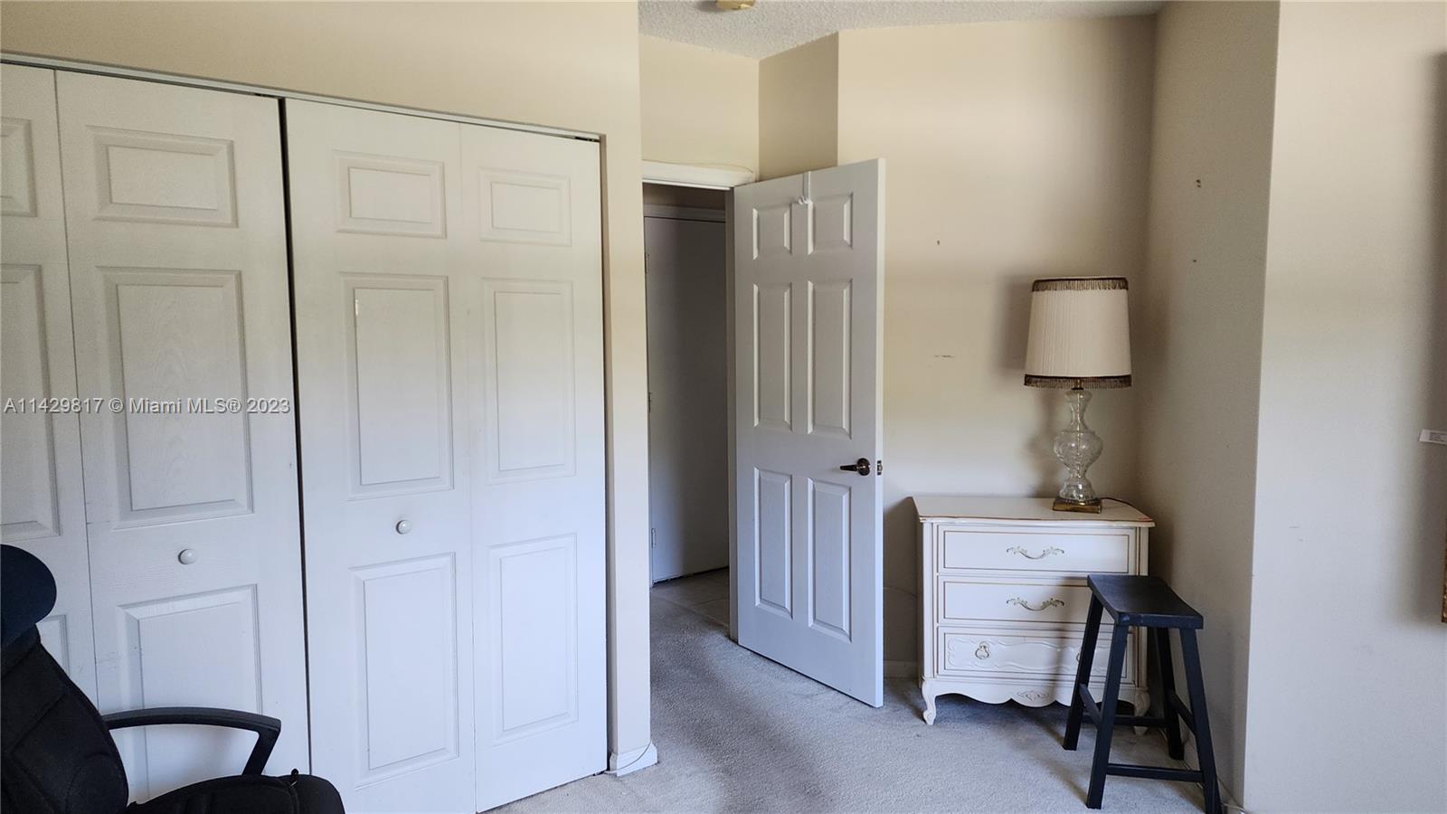 21128 Vía Solano Boca Raton, FL 33433 - Photo 12 of 25 a bedroom with a bed and a lamp