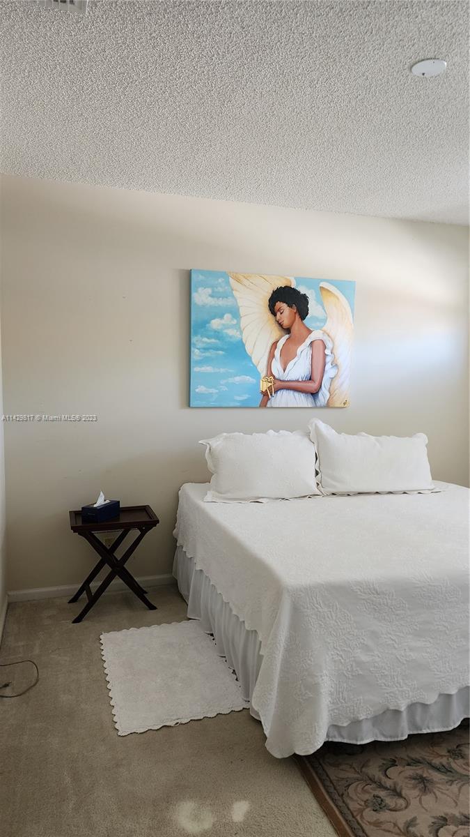 21128 Vía Solano Boca Raton, FL 33433 - Photo 14 of 25 a bedroom with a bed and ceiling fan