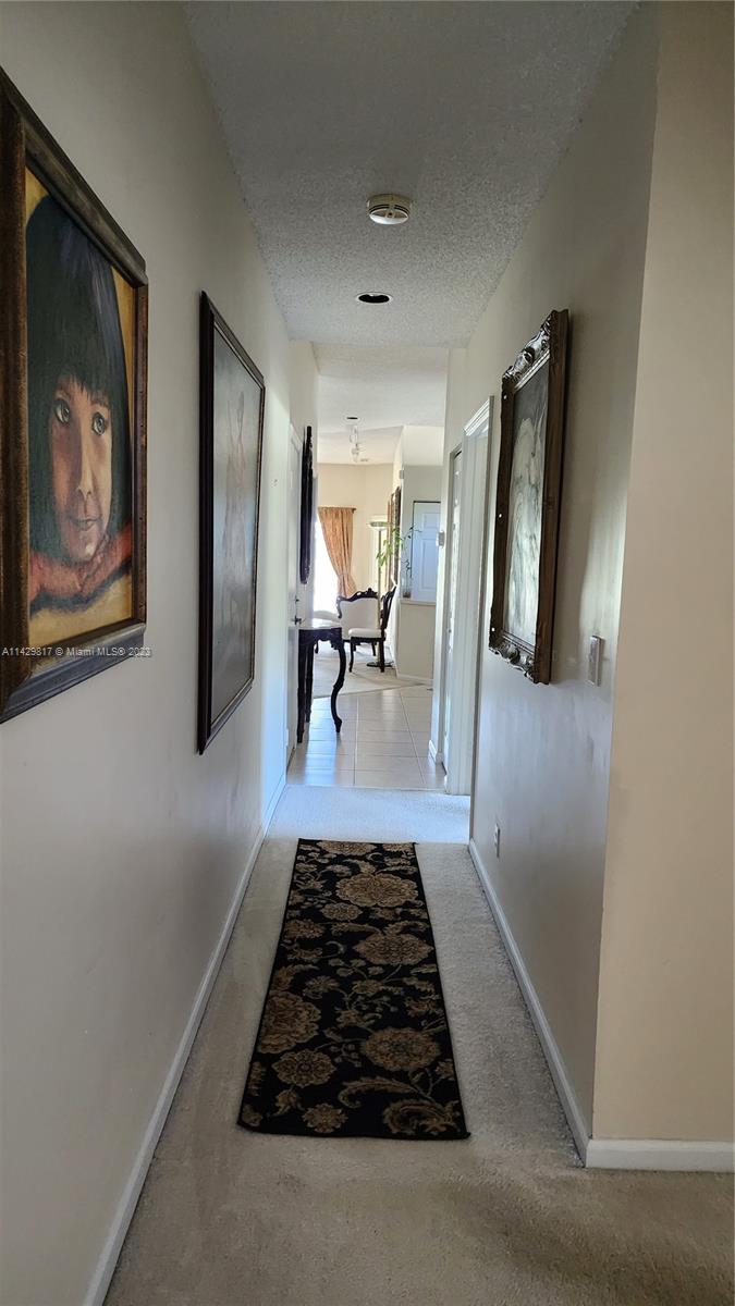 21128 Vía Solano Boca Raton, FL 33433 - Photo 17 of 25 a view of a hallway view with furniture and lamp