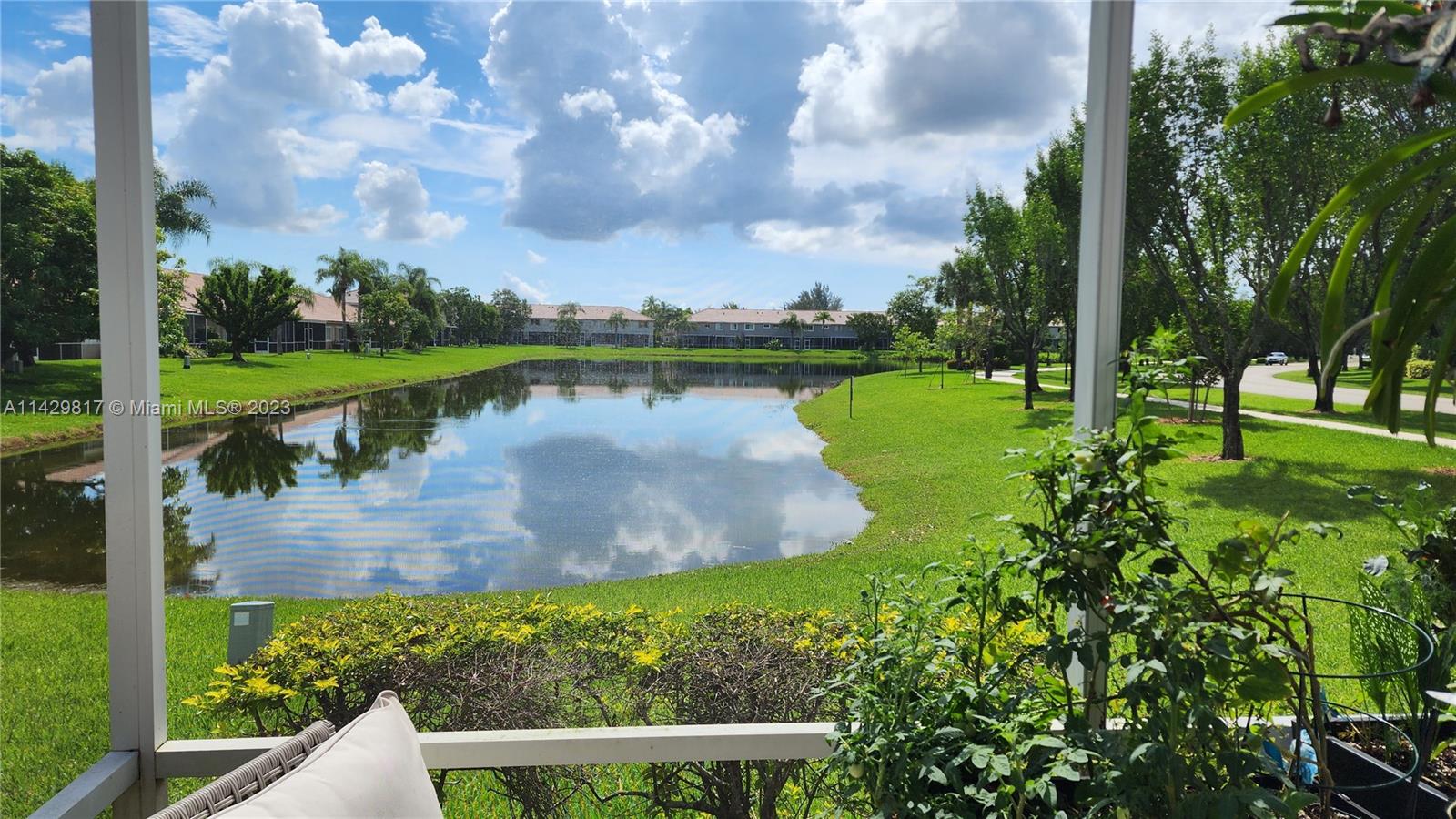 21128 Vía Solano Boca Raton, FL 33433 - Photo 20 of 25 a view of a lake with a yard