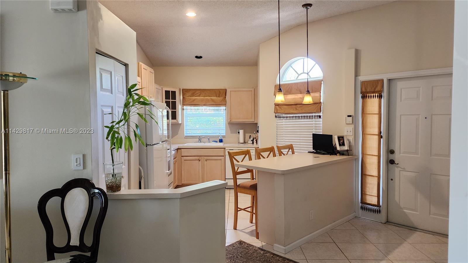 21128 Vía Solano Boca Raton, FL 33433 - Photo 23 of 25 a view of a kitchen with a sink a window and living room