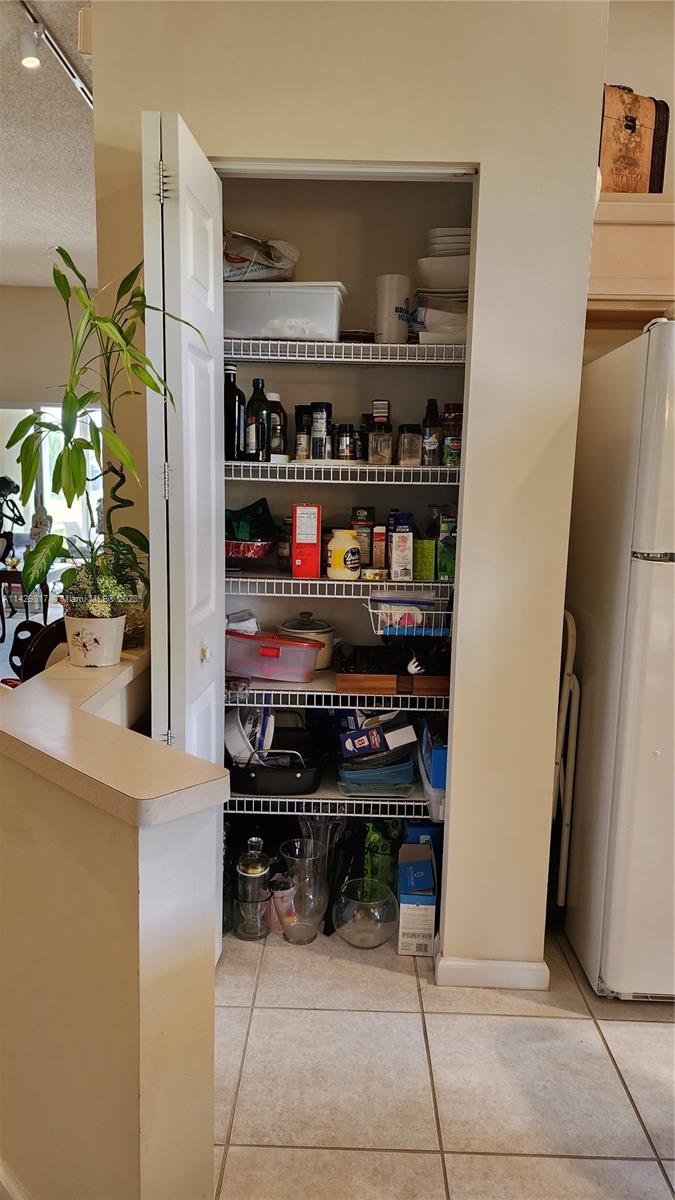 21128 Vía Solano Boca Raton, FL 33433 - Photo 24 of 25 a kitchen with stainless steel appliances a refrigerator and a counter
