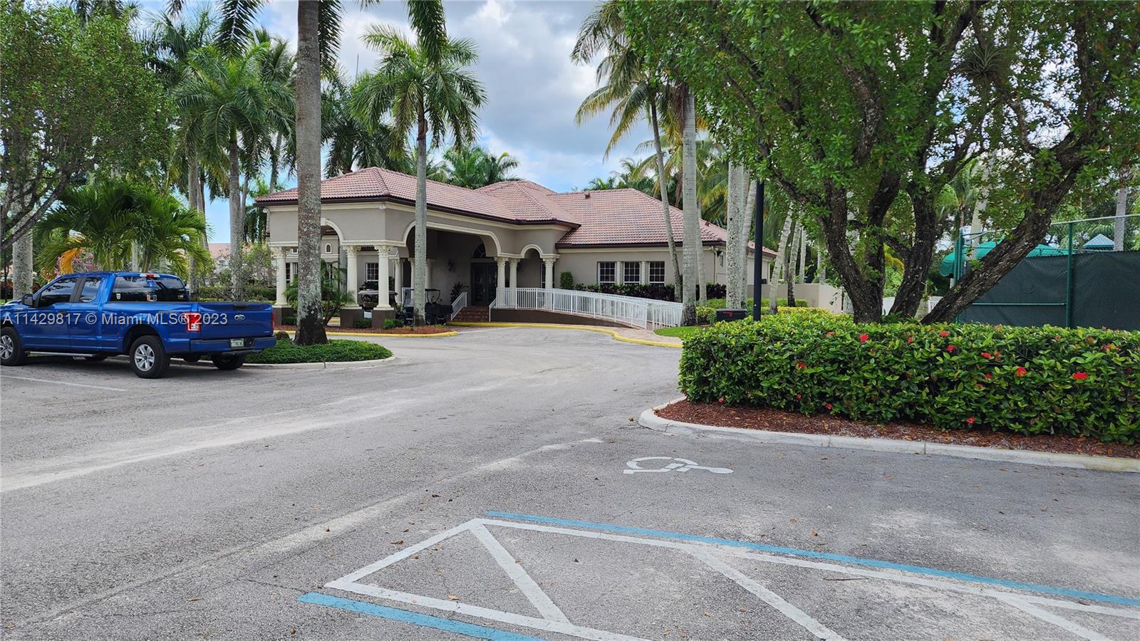 21128 Vía Solano Boca Raton, FL 33433 - Photo 4 of 25 front view of a house with a garden