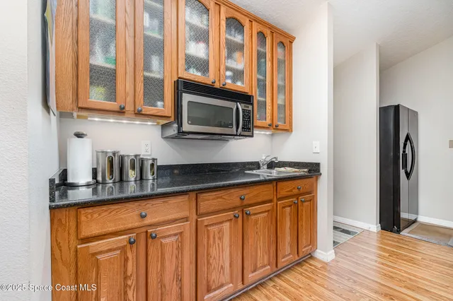 a kitchen with stainless steel appliances granite countertop a refrigerator and cabinets