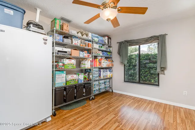 a room with lots of books and a large window