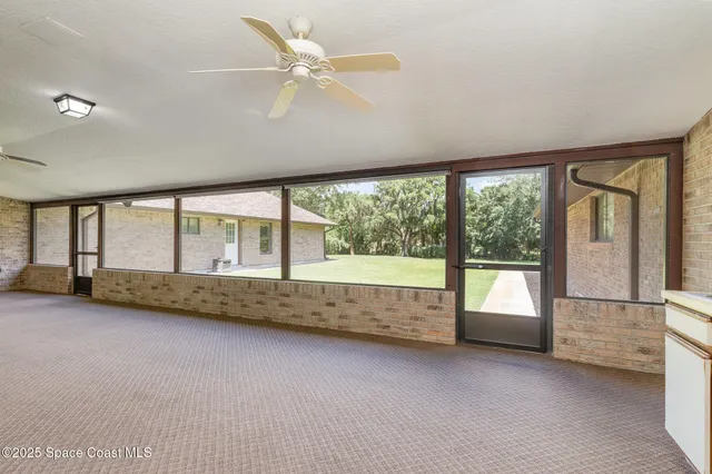 an empty room with windows and view