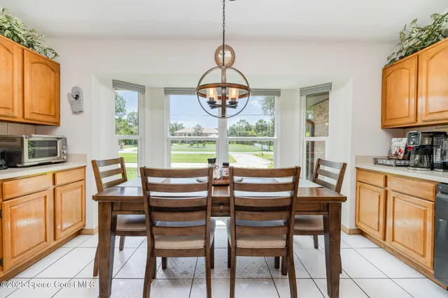 a dining room with furniture a chandelier and wooden floor