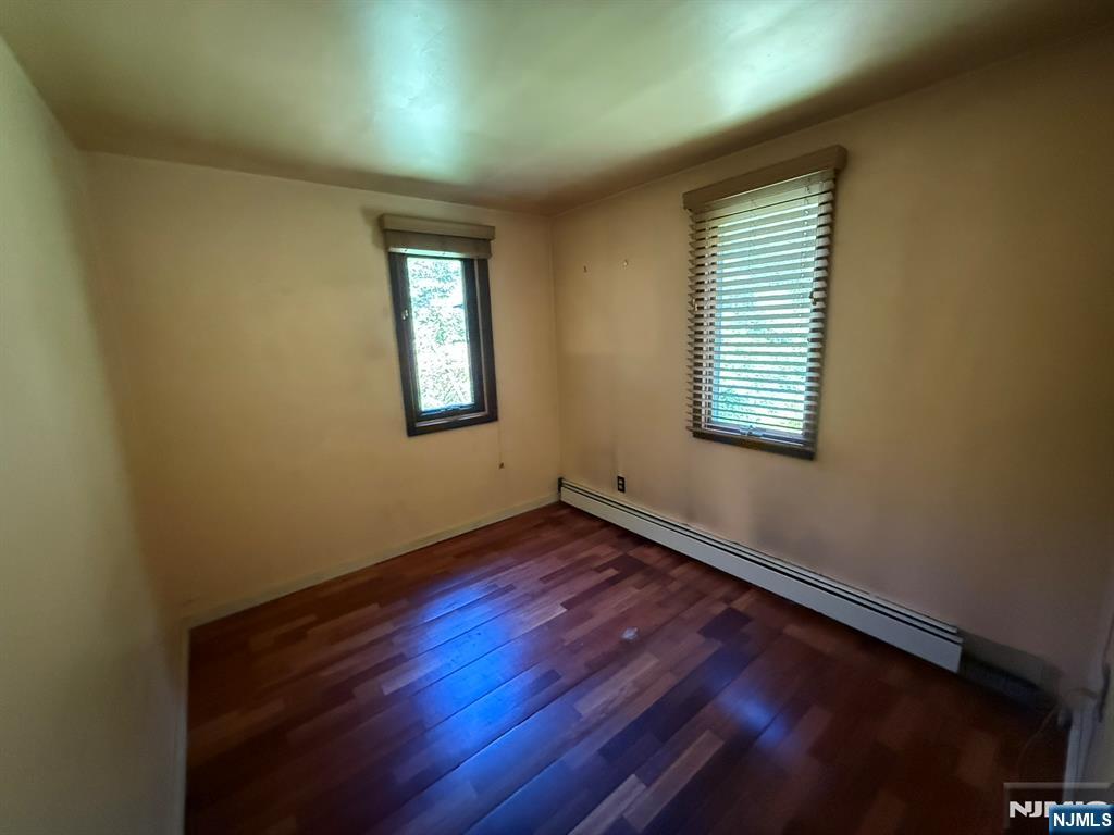 78 Woodland Road Ringwood, NJ 07456 - Photo 15 of 33 a view of an empty room with wooden floor and a window