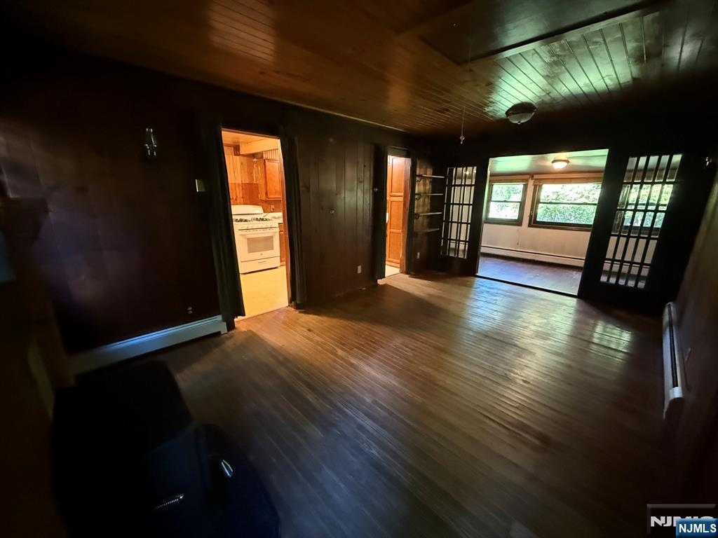 78 Woodland Road Ringwood, NJ 07456 - Photo 16 of 33 a view of empty room with wooden floor and fan