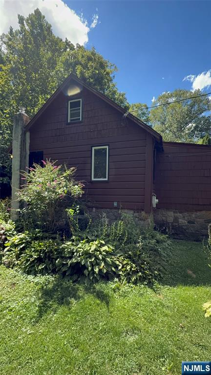 78 Woodland Road Ringwood, NJ 07456 - Photo 23 of 33 a brick house with a yard in front of it
