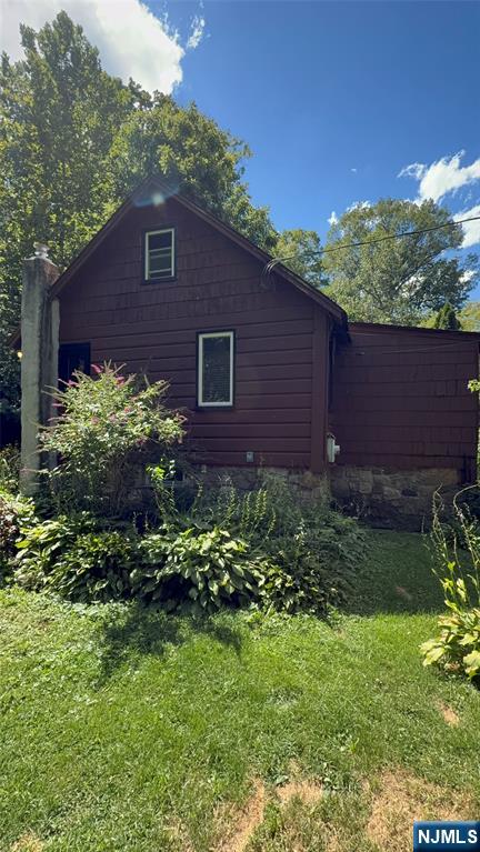 78 Woodland Road Ringwood, NJ 07456 - Photo 24 of 33 a brick house with a small yard