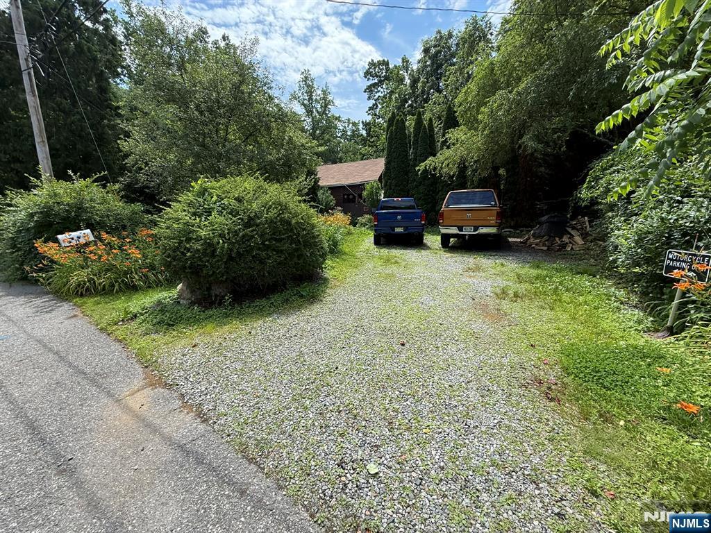 78 Woodland Road Ringwood, NJ 07456 - Photo 31 of 33 a car parked in front of a white house