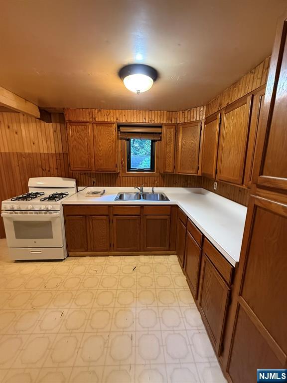 78 Woodland Road Ringwood, NJ 07456 - Photo 9 of 33 a kitchen with stainless steel appliances granite countertop a stove a sink and a microwave