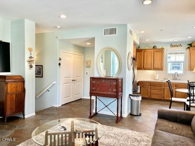 a living room with furniture a dining table a lamp and a window