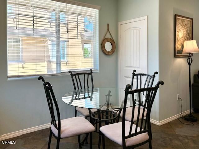 a view of a dining room with furniture and window
