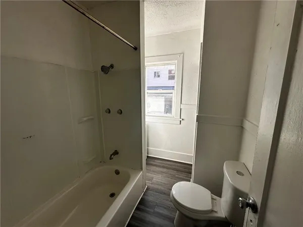 a bathroom with a tub a toilet and a sink