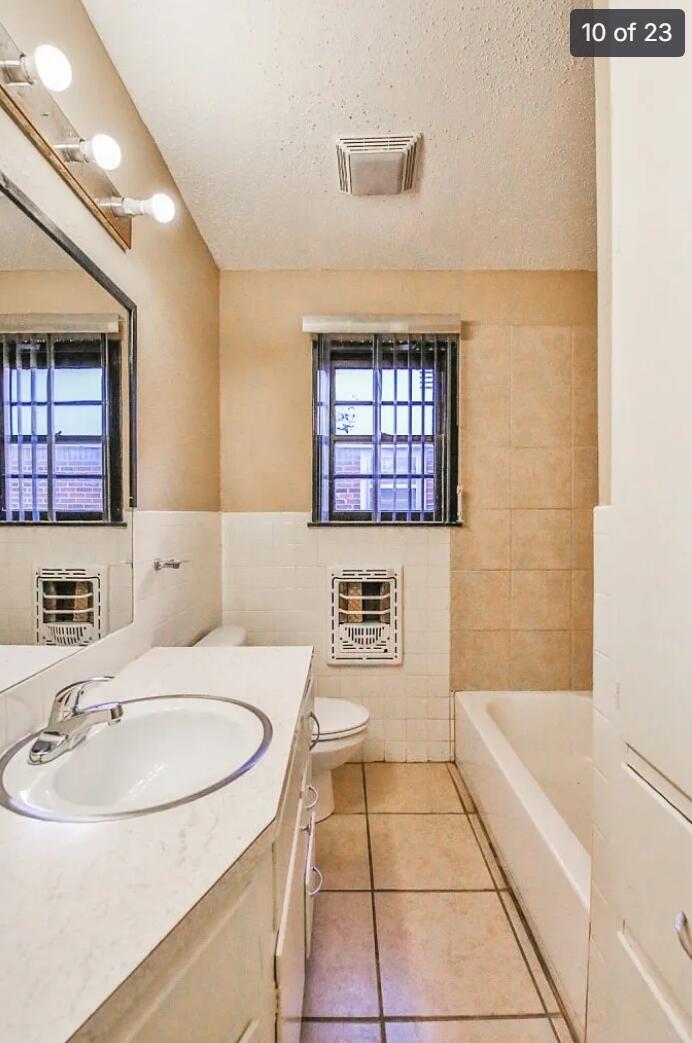 5426 33rd Street Lubbock, TX 79407 - Photo 13 of 27 a bathroom with a sink a bathtub and a mirror