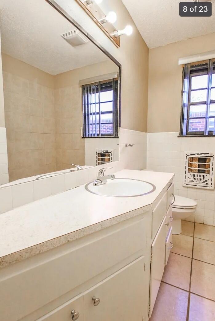 5426 33rd Street Lubbock, TX 79407 - Photo 14 of 27 a bathroom with a sink a vanity and a mirror