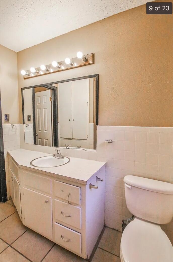 5426 33rd Street Lubbock, TX 79407 - Photo 15 of 27 a bathroom with a granite countertop toilet sink and mirror