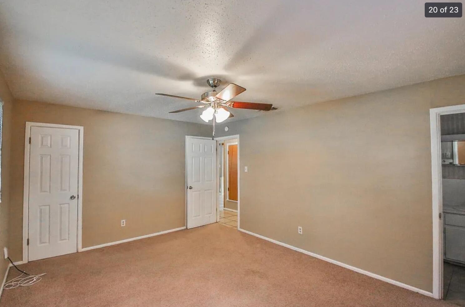 5426 33rd Street Lubbock, TX 79407 - Photo 17 of 27 an empty room with a chandelier fan and closet area