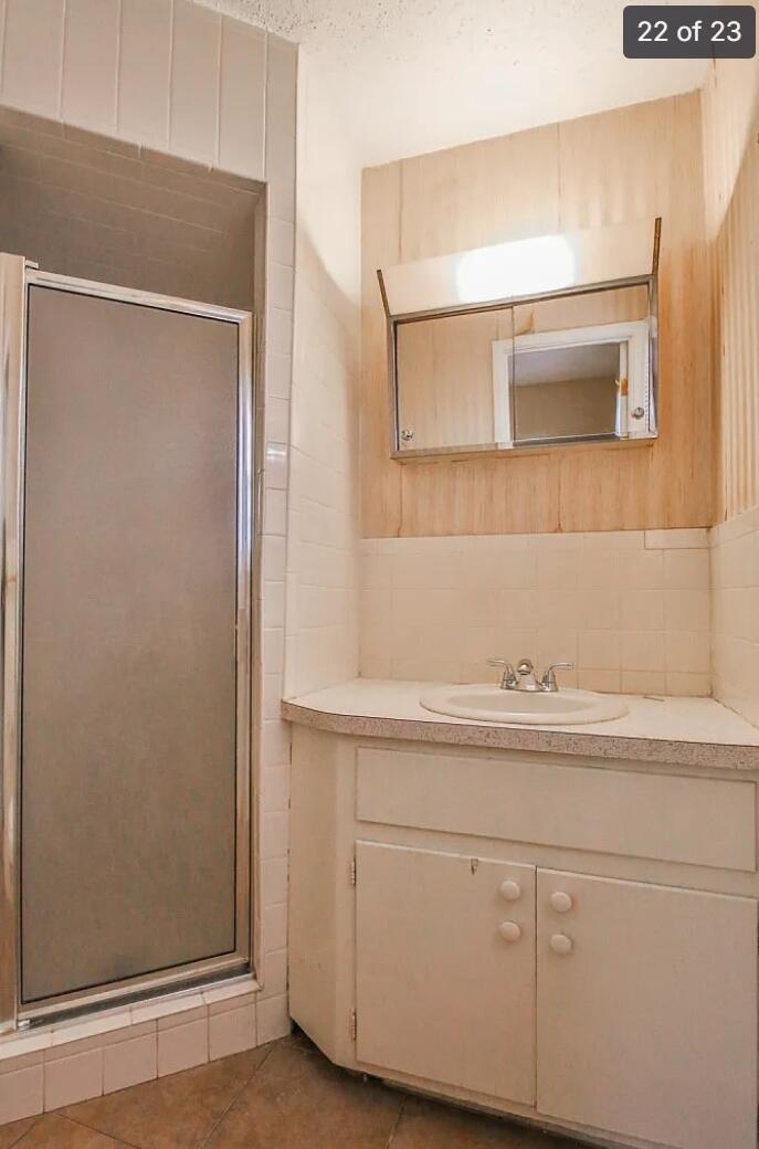 5426 33rd Street Lubbock, TX 79407 - Photo 20 of 27 a bathroom with a sink and a mirror
