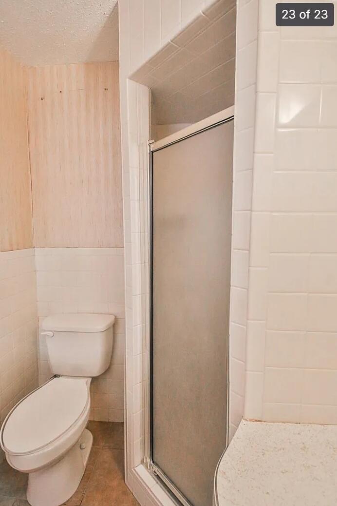 5426 33rd Street Lubbock, TX 79407 - Photo 21 of 27 a white toilet sitting next to a bathroom sink