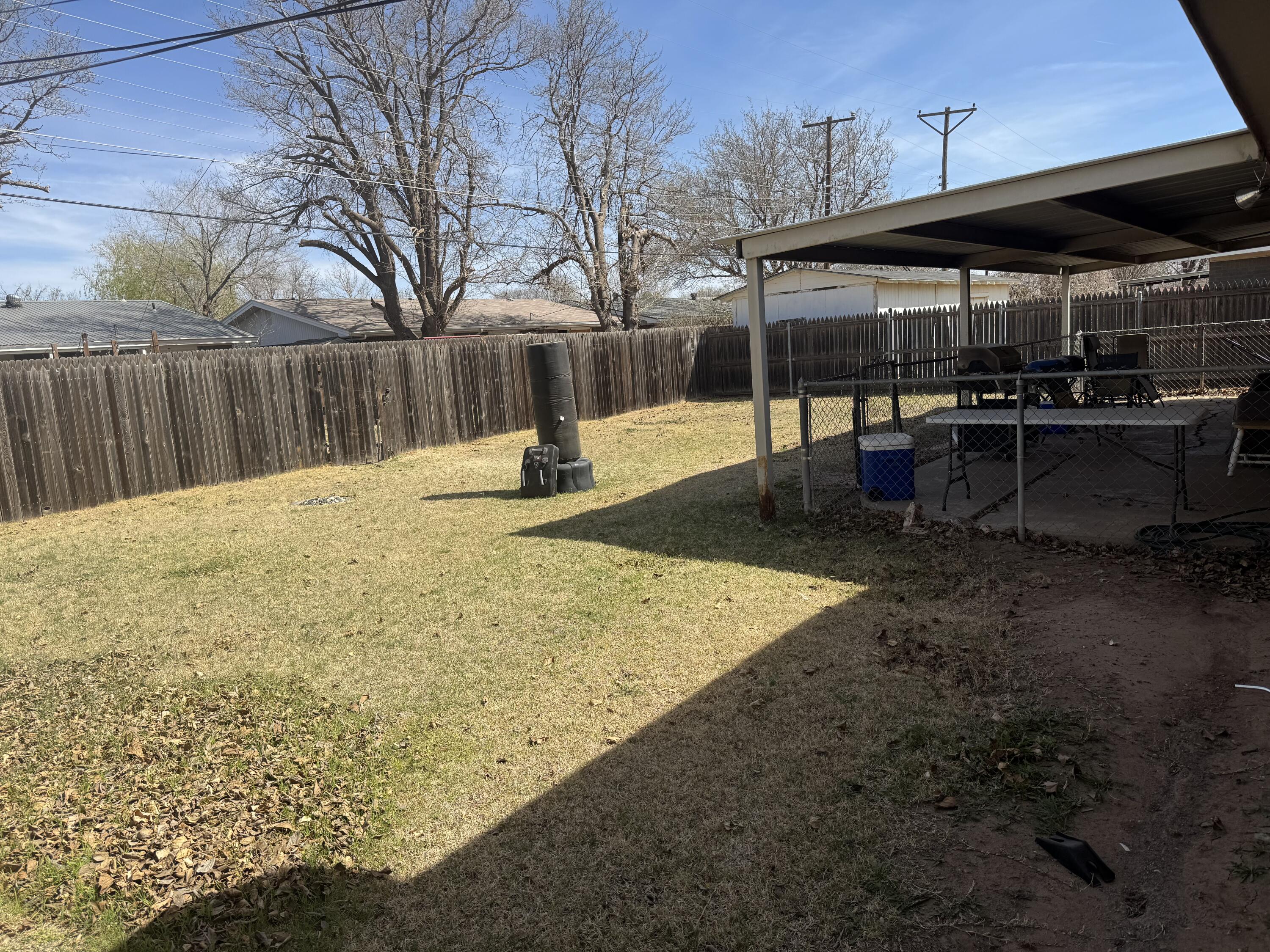 5426 33rd Street Lubbock, TX 79407 - Photo 23 of 27 a backyard of a house with barbeque oven fire pit table and chairs