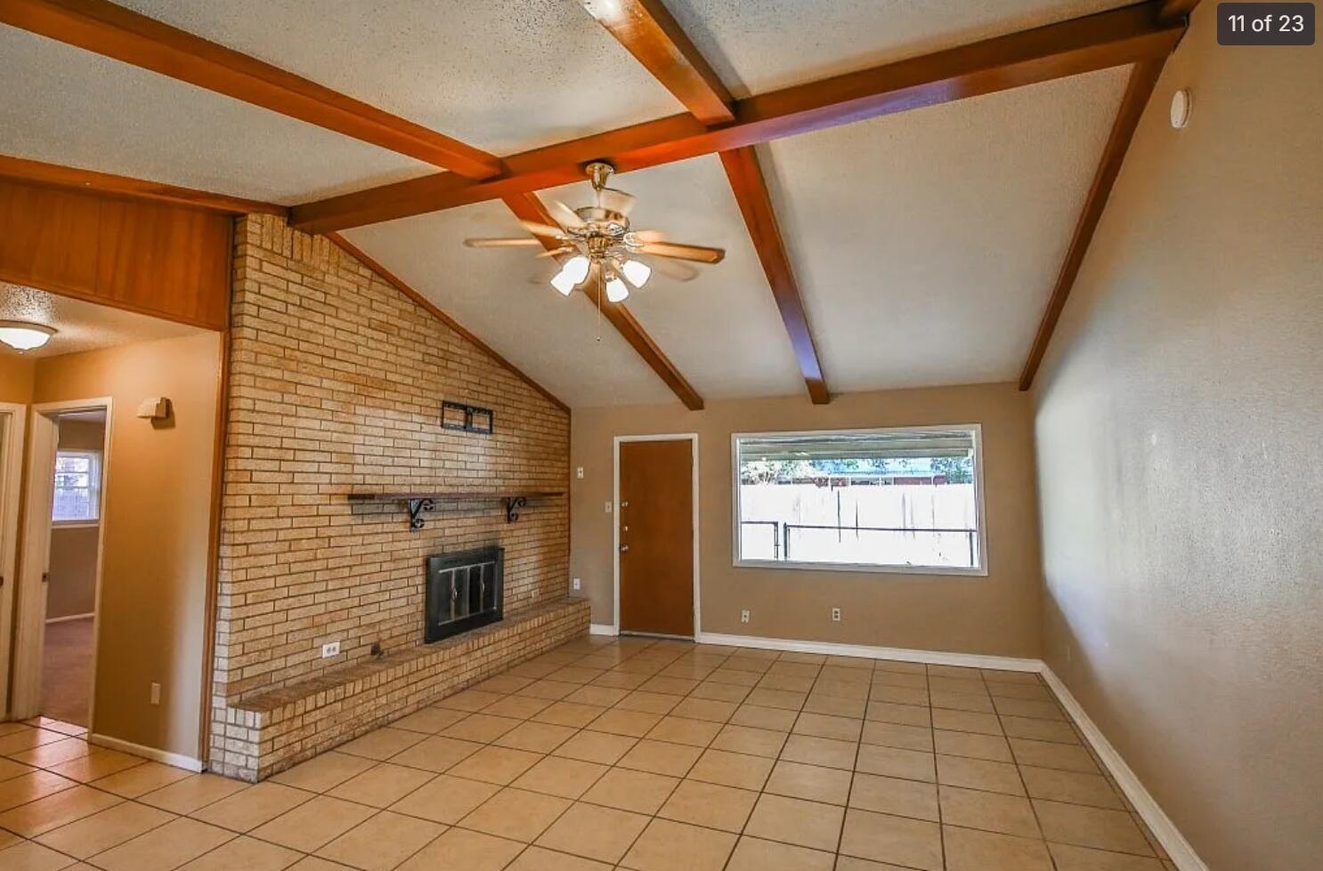 5426 33rd Street Lubbock, TX 79407 - Photo 3 of 27 a view of an empty room with window and fire place