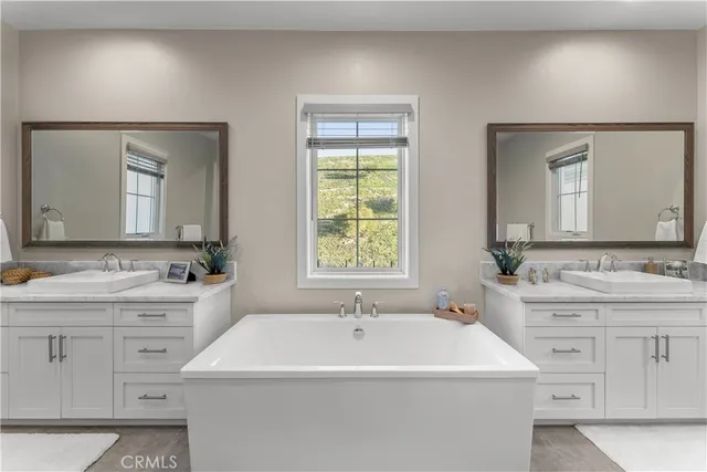 a bathroom with a double vanity sink mirror and a