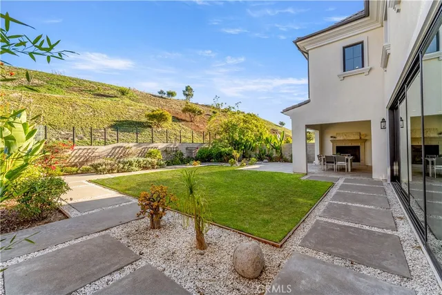 a view of a patio with a table and chairs and potted plants