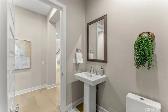 a bathroom with a sink a mirror and a toilet