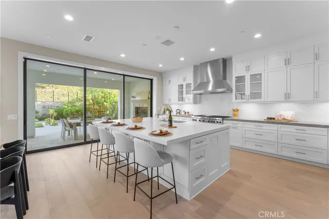 a kitchen with a sink and white cabinets