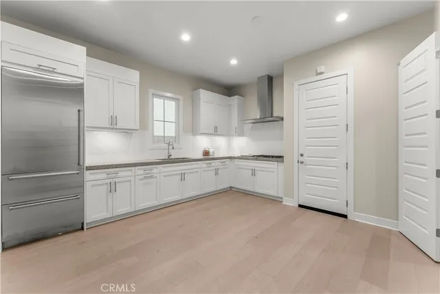 a kitchen with white cabinets and white appliances