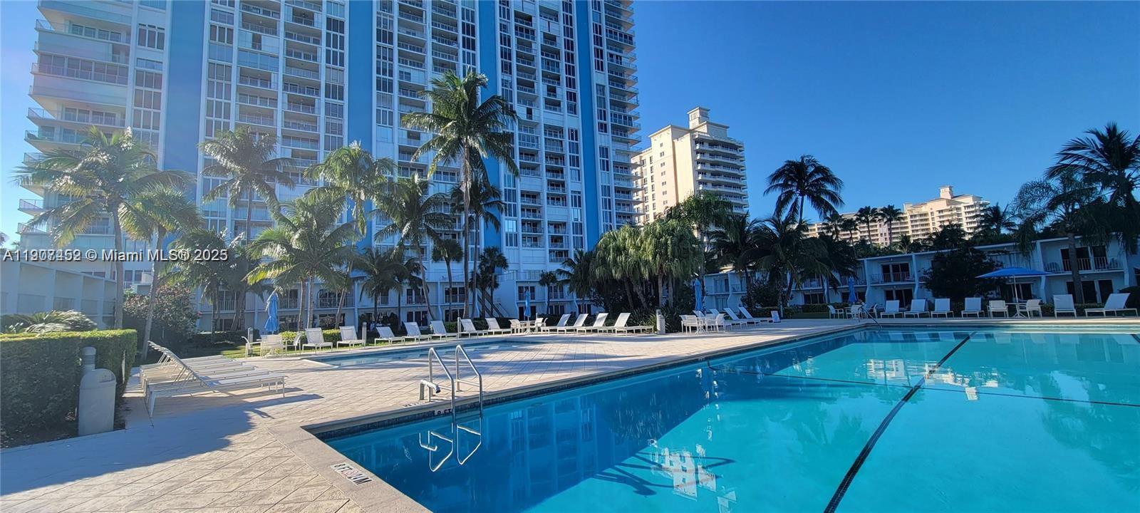 881 Ocean Drive, Unit TH10 Key Biscayne, FL 33149 - Photo 18 of 18 a view of a house with a swimming pool