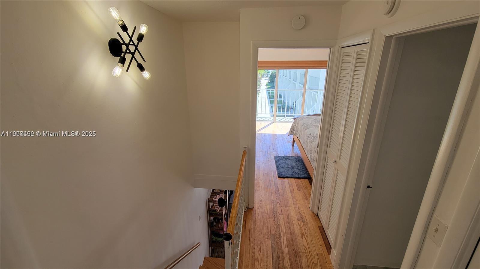 881 Ocean Drive, Unit TH10 Key Biscayne, FL 33149 - Photo 4 of 18 a view of a hallway with wooden floor and entryway