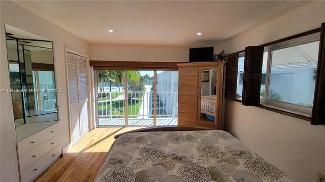 a bedroom with a large bed and a large window