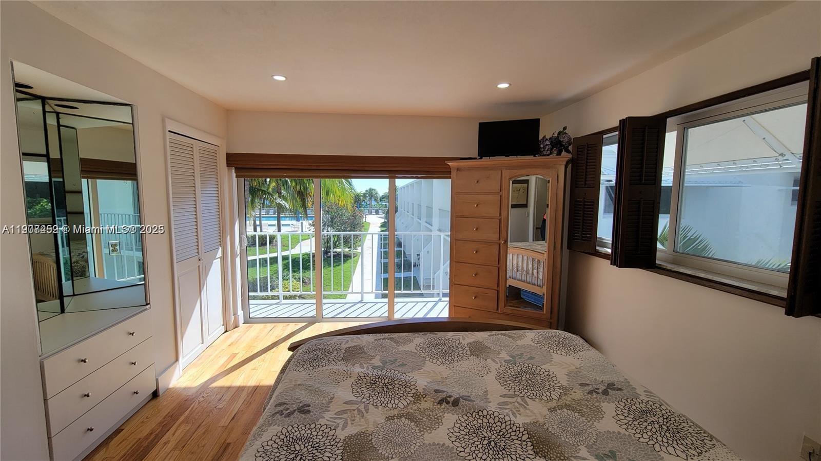 881 Ocean Drive, Unit TH10 Key Biscayne, FL 33149 - Photo 6 of 18 a bedroom with a large bed and a large window