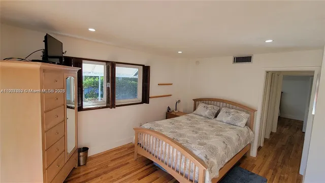 a bedroom with a large bed and a window