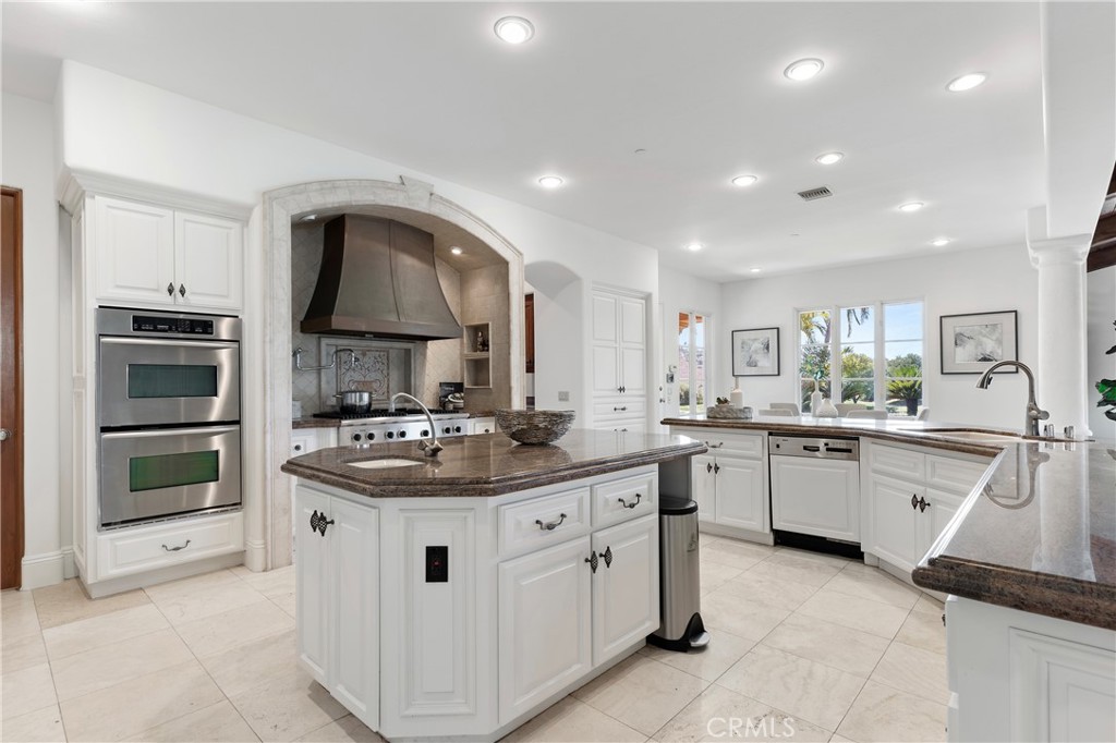 18090 Old Coach Drive Poway, CA 92064 - Photo 26 of 75 a kitchen with sink stove and cabinets