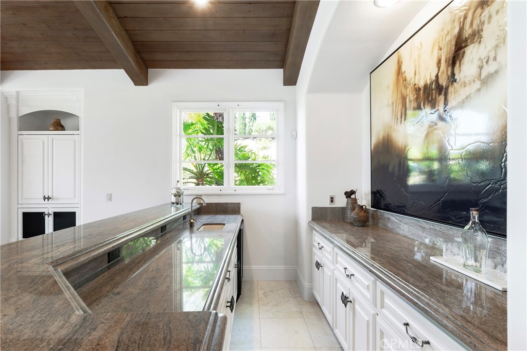 18090 Old Coach Drive Poway, CA 92064 - Photo 30 of 75 a large kitchen with granite countertop a sink and a window