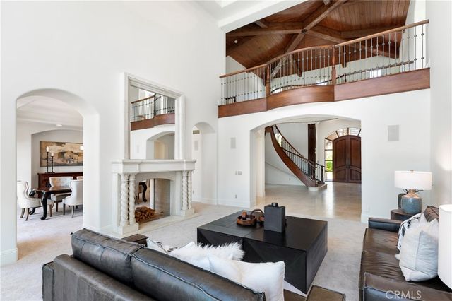 a dining room with furniture a chandelier and window