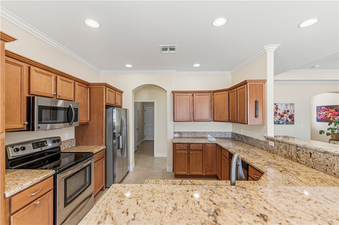 3315 Rainbow Mine Road Kingman, AZ 86401 - Photo 14 of 54 The kitchen features wood cabinetry, stainless steel appliances, and granite countertops