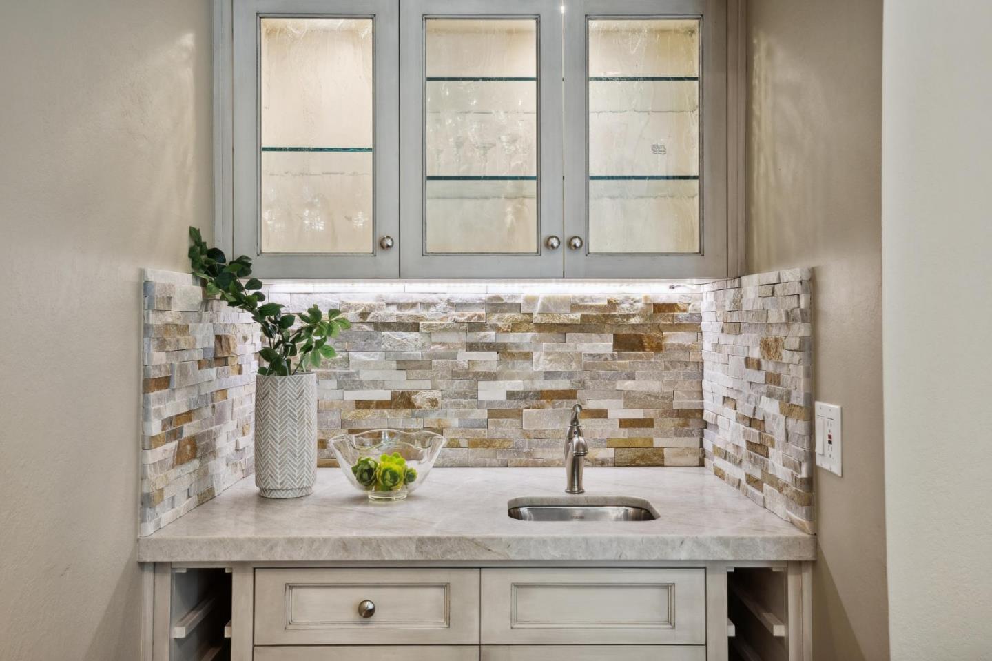 3850 Rio Road, Unit 1 Carmel, CA 93923 - Photo 11 of 46 a bathroom with a granite countertop sink a mirror and a shower