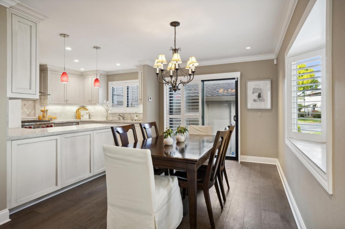 3850 Rio Road, Unit 1 Carmel, CA 93923 - Photo 13 of 46 a kitchen that has a dining table chairs and window