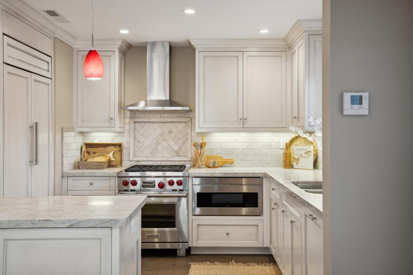 3850 Rio Road, Unit 1 Carmel, CA 93923 - Photo 15 of 46 a kitchen with stainless steel appliances granite countertop a stove and a white cabinets